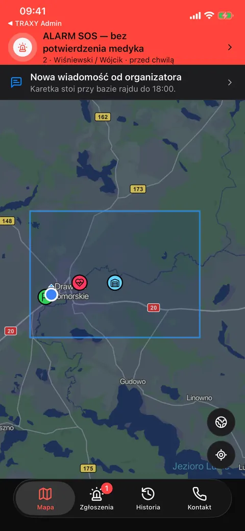 TRAXY Med: mapa z paskiem „Alarm SOS — bez potwierdzenia medyka”, znacznikiem zgłoszenia, pozycjami załóg i granicą terenu